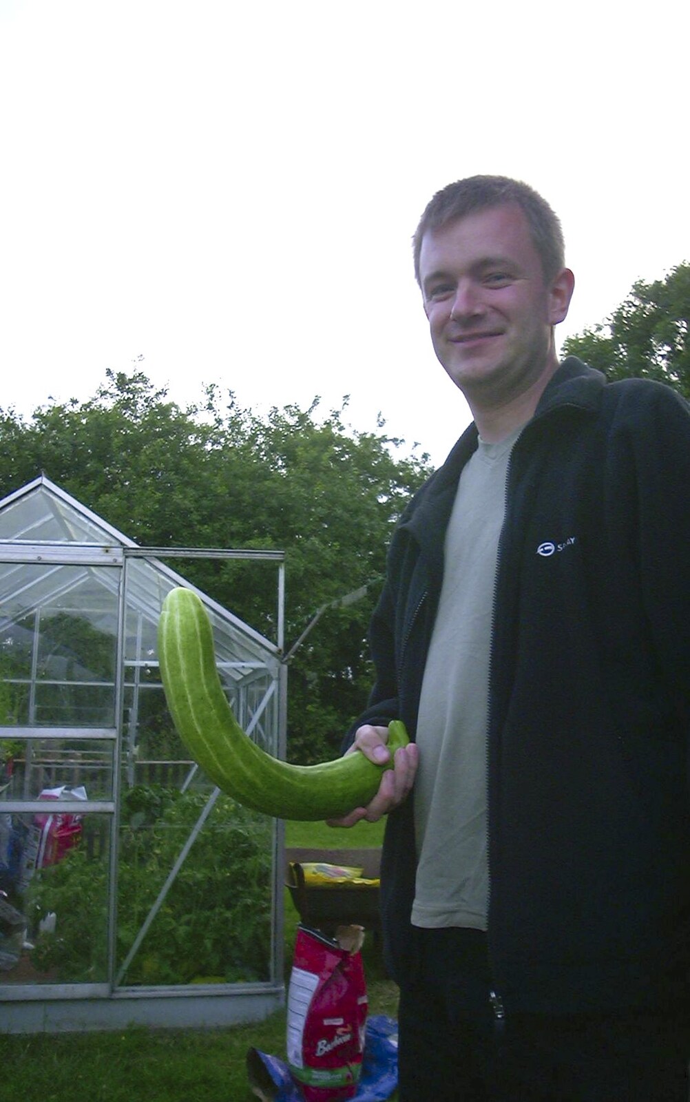 Nosher's got a cucumber out of the greenhouse from 3G Lab at Henry's and a Barbeque, Brome, Suffolk - 21st June 2003