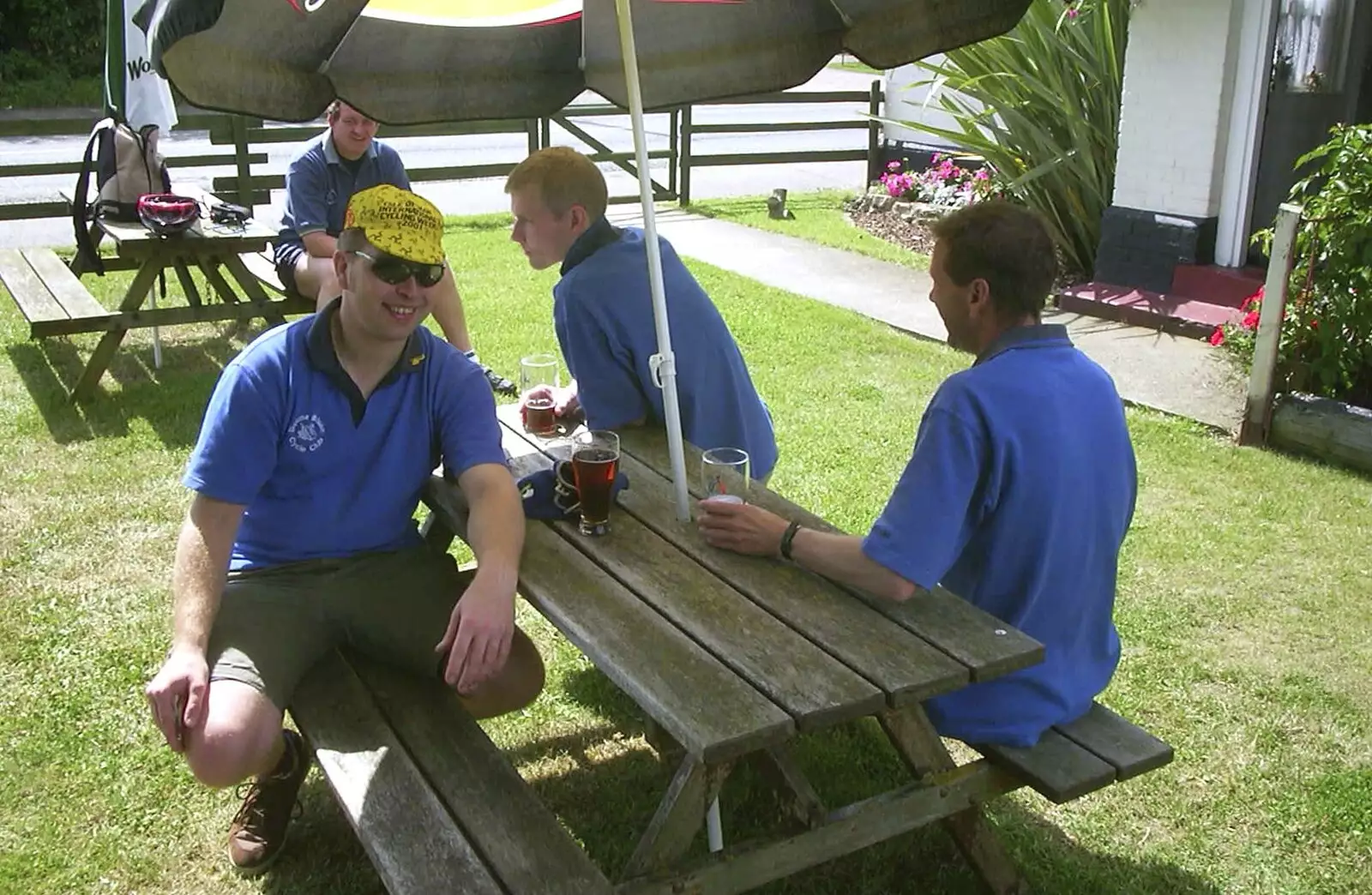 Marc, Bill and Apple under a parasol, from The BSCC Annual Bike Ride, Orford, Suffolk - 12th July 2003