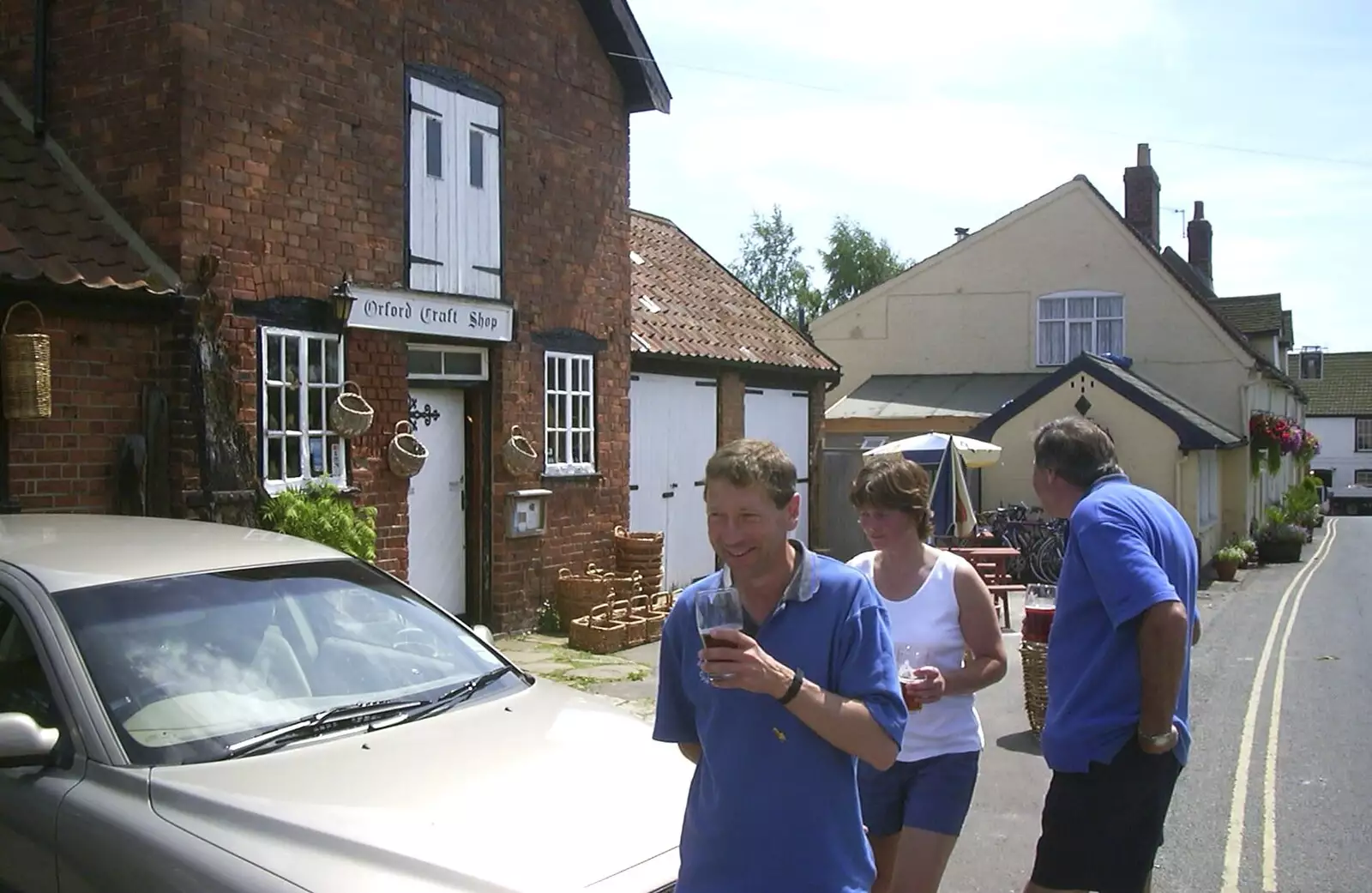 Apple, Pippa and Al bring back beer from the bar, from The BSCC Annual Bike Ride, Orford, Suffolk - 12th July 2003