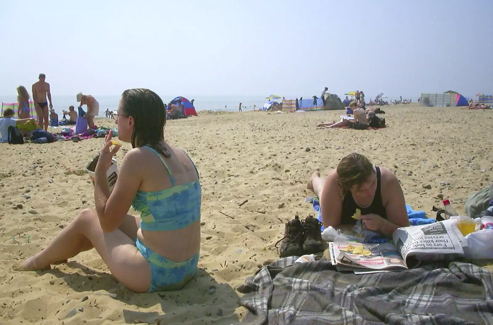 Sarah reads the paper on the beach, from A BSCC Camping Trip to the Fox Inn, Shadingfield, Suffolk - 9th August 2003