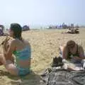 Sarah reads the paper on the beach, A BSCC Camping Trip to the Fox Inn, Shadingfield, Suffolk - 9th August 2003