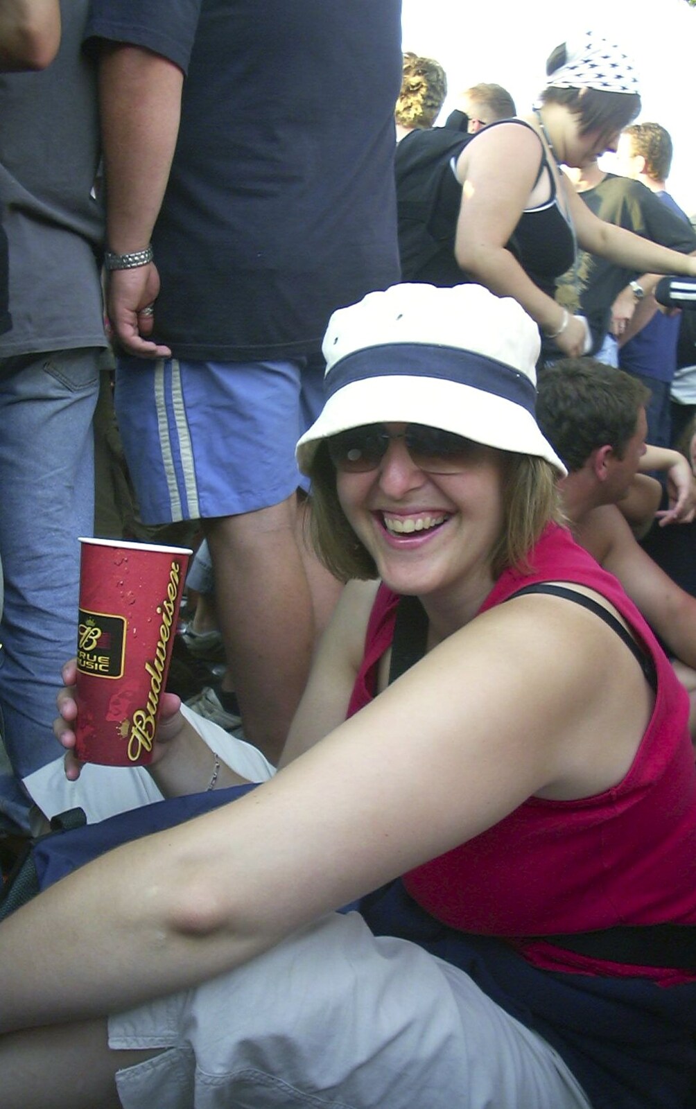 Sarah sits down in a crowd from V Festival 2003, Hyland's Park, Chelmsford, Essex - 16th August 2003