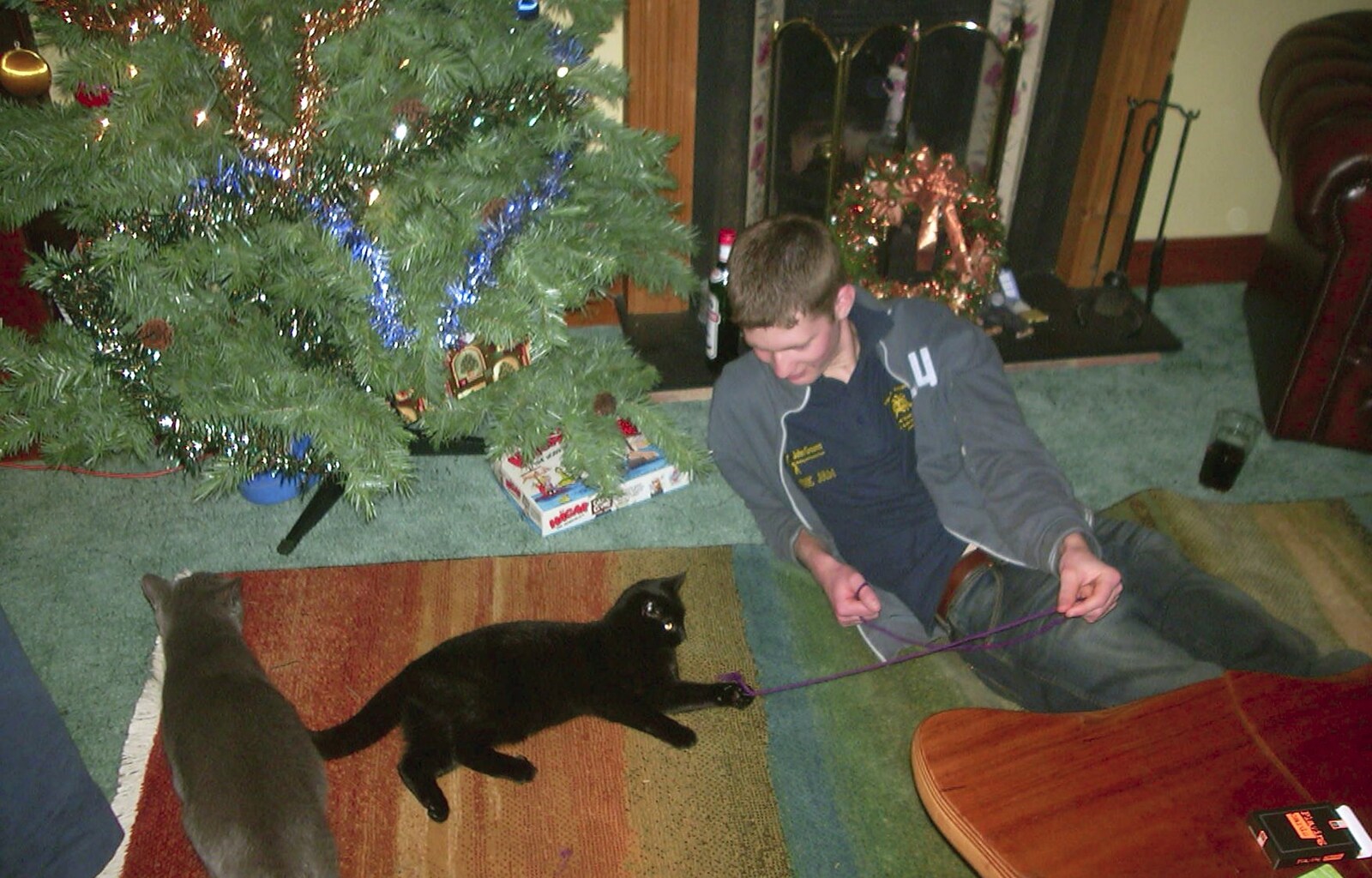 Phil teases Mini the cat with string from Sarah's Games Night at Anne's, Thornham, Suffolk - 27th December 2003