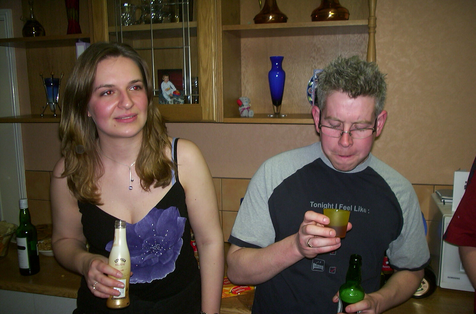 Jess looks over whilst John queries the shot from Jess and Jen's Party, Pulham St. Mary, Norfolk - 28th February 2004