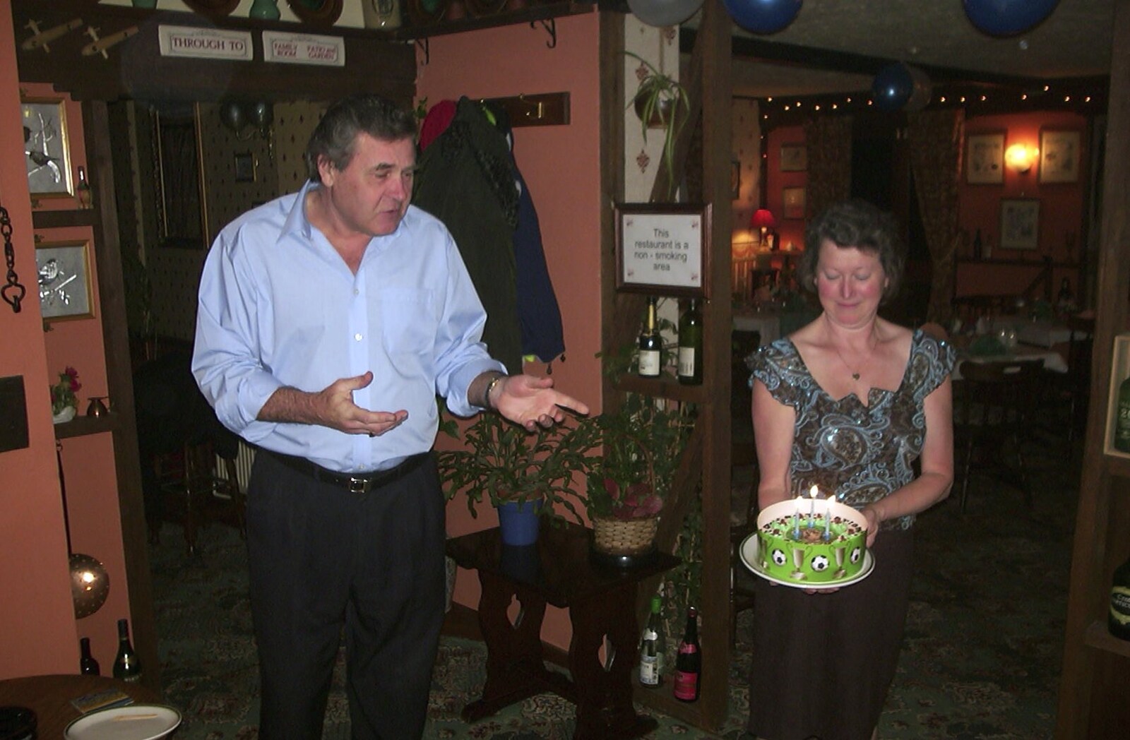 Sylvia brings a cake out from Paul and Claire's Engagement Party, Brome Swan, Suffolk - 27th March 2004
