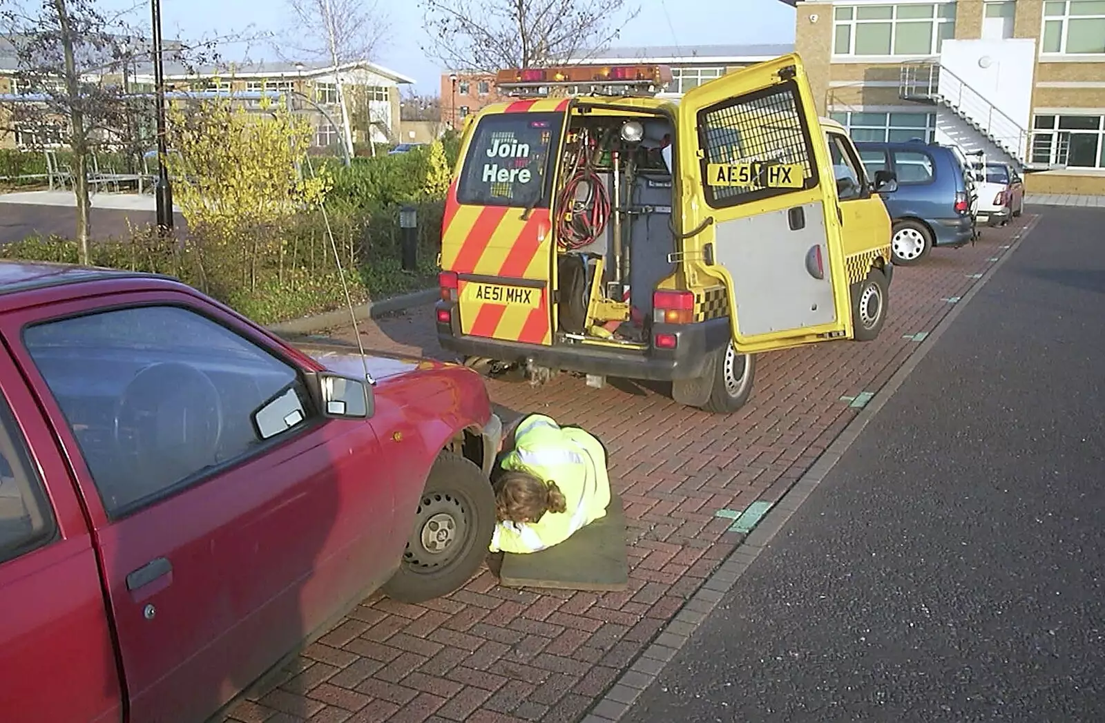 The AA man pokes around under the car, from A March Miscellany: The BBs, Pulham Pubs and Broken Cars - Norfolk and Cambridgeshire, 31st March 2004