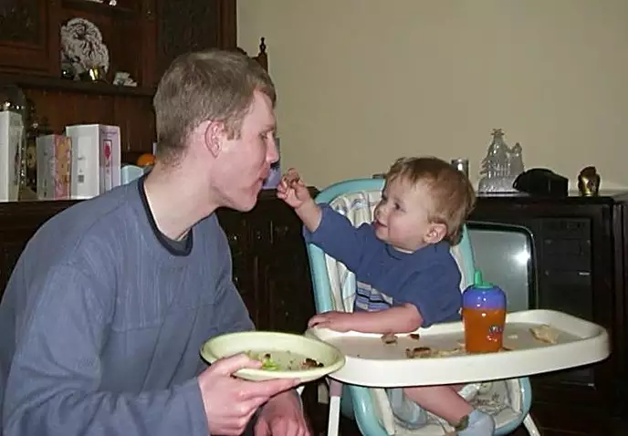 Tyler feeds Andy a bit of burger, from Jess's Post-Birthday Barbeque and a Walk Around Pulham - 4th April 2004