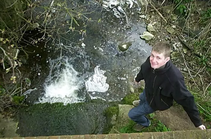 Phil's Pooh Stick gets stuck under the bridge, from Jess's Post-Birthday Barbeque and a Walk Around Pulham - 4th April 2004