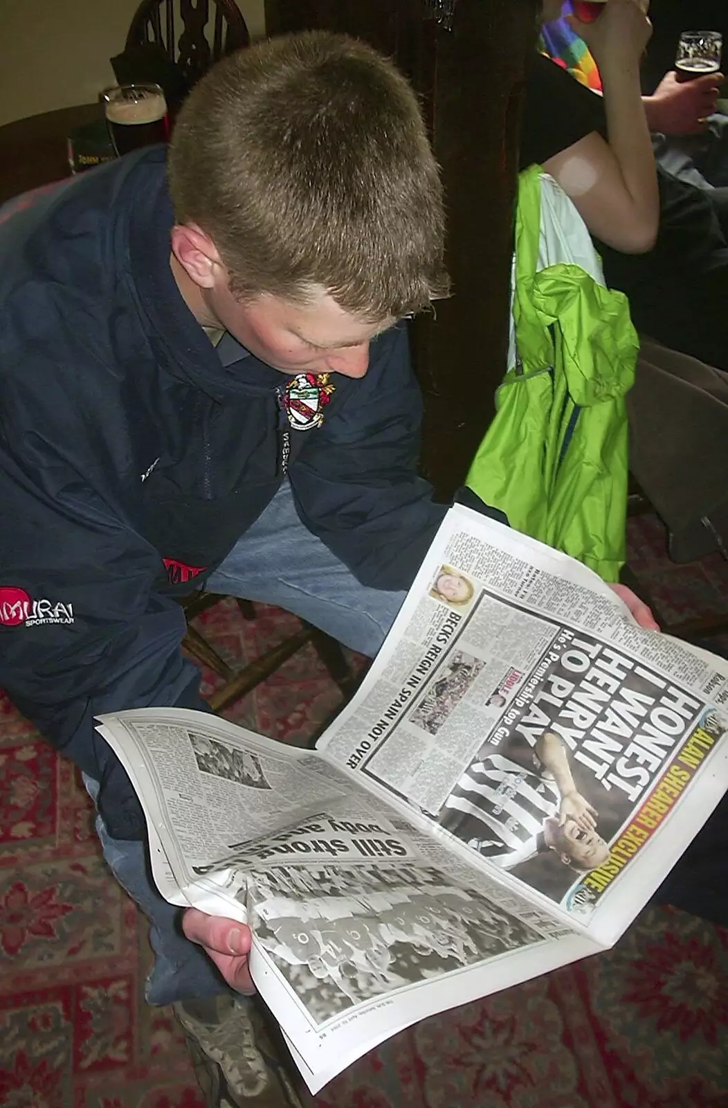 The Boy Phil reads the papers, from The BSCC Easter Bike Ride, Thelnetham and Redgrave, Suffolk - 10th April 2004