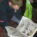 The Boy Phil reads the papers, The BSCC Easter Bike Ride, Thelnetham and Redgrave, Suffolk - 10th April 2004