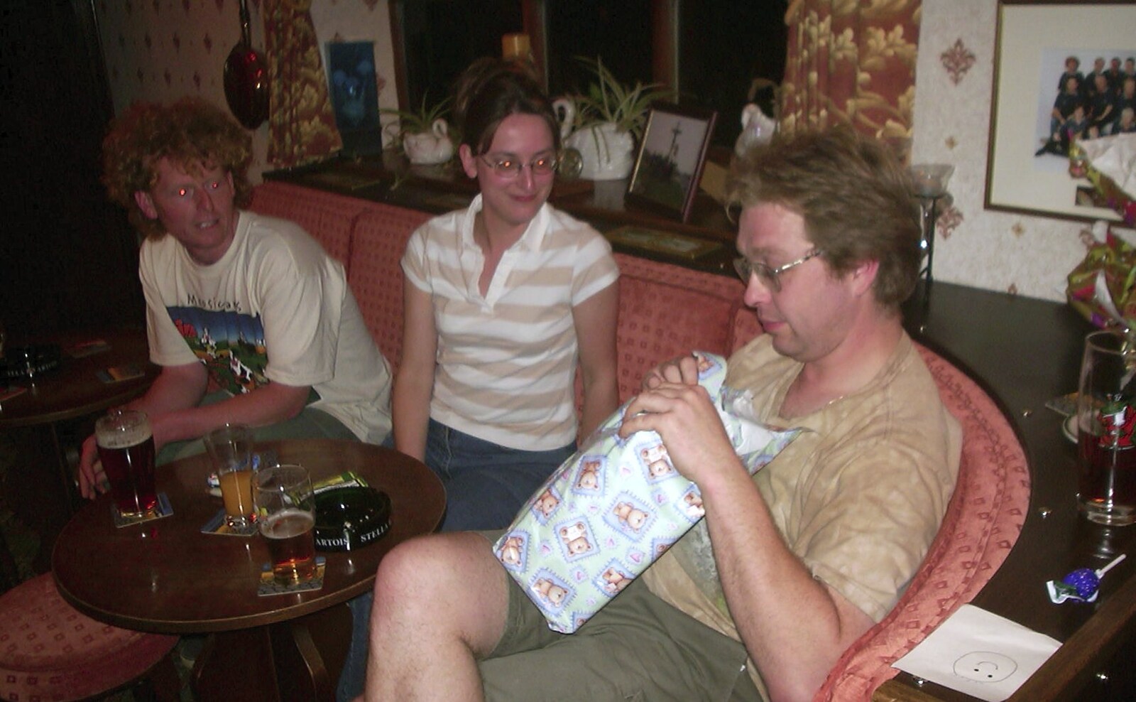 Marc gets first go at 'pass the parcel' from Wavy's Birthday at the Swan Inn, Brome, Suffolk - 24th May 2004