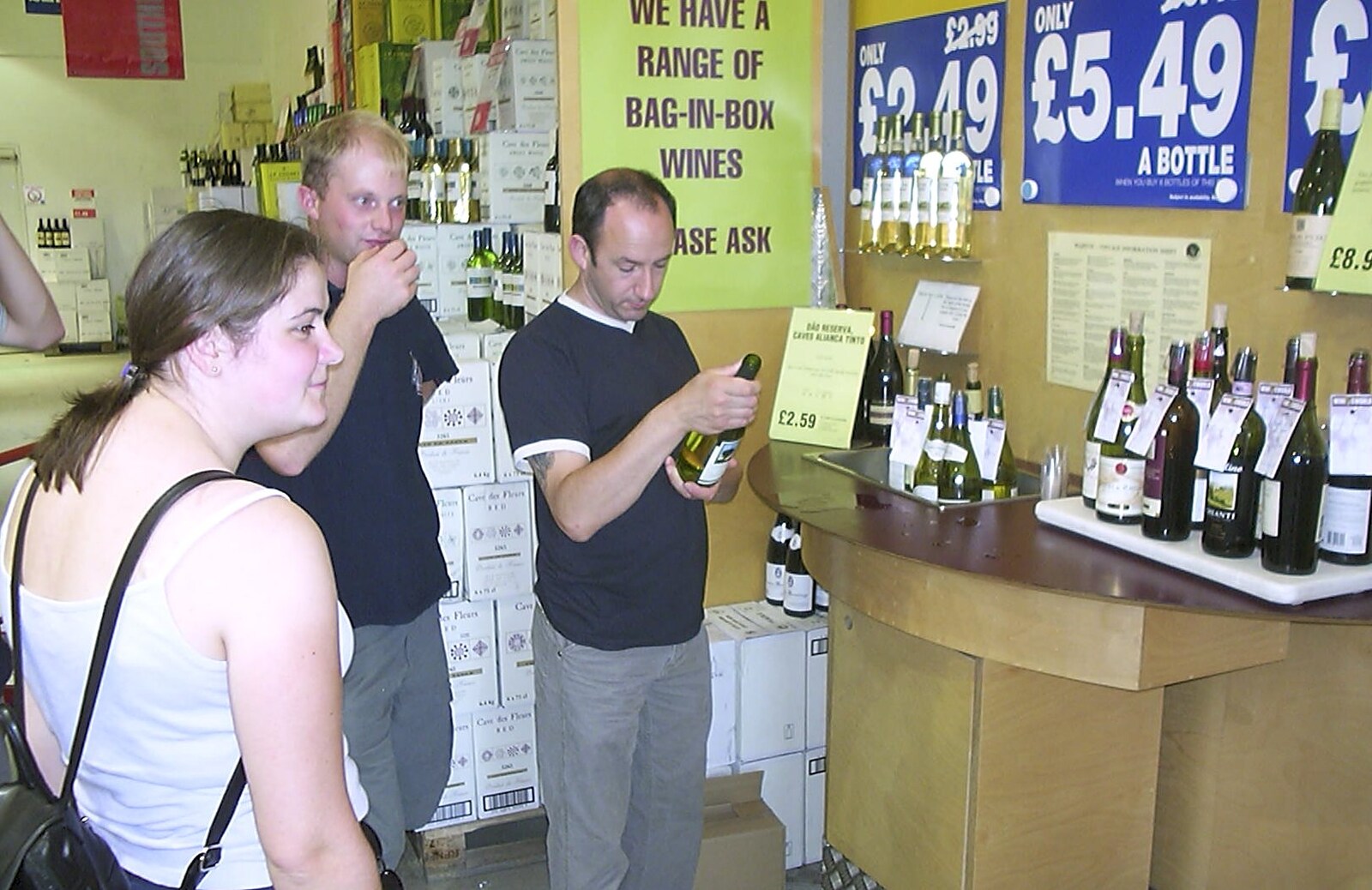 DH looks at wine from A Brome Swan Trip to Calais and the Battery Todt, Cap Gris Nez, France - 11th August 2004