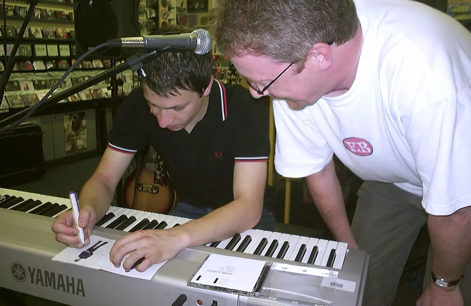 Mark signs some CDs, from Mark Joseph at Revs, and the BSCC at Hoxne and Wortham - 30th September 2004