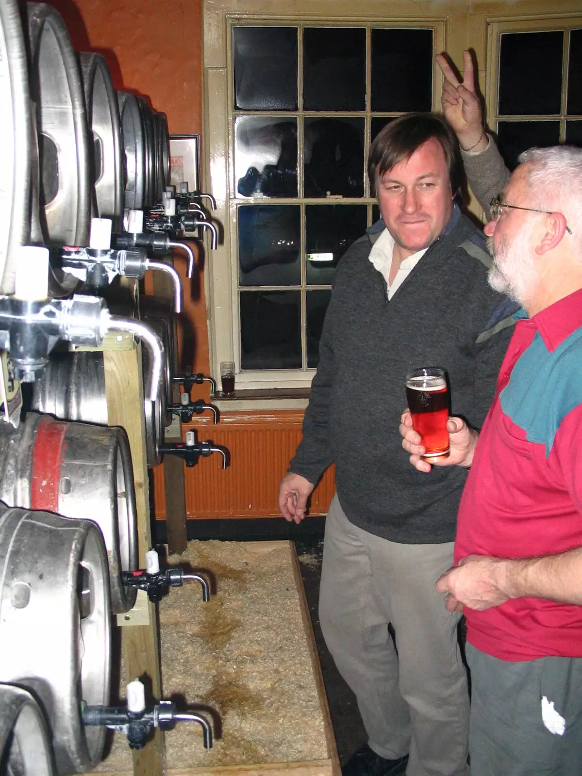 Someone does rabbit ears on the landlord, from The Hoxne Swan Beer Festival, Hoxne, Suffolk - 20th November 2004