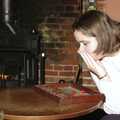 Claire ponders her dice throw, Christmas Day at the Brome Swan, Brome, Suffolk - 25th December 2004