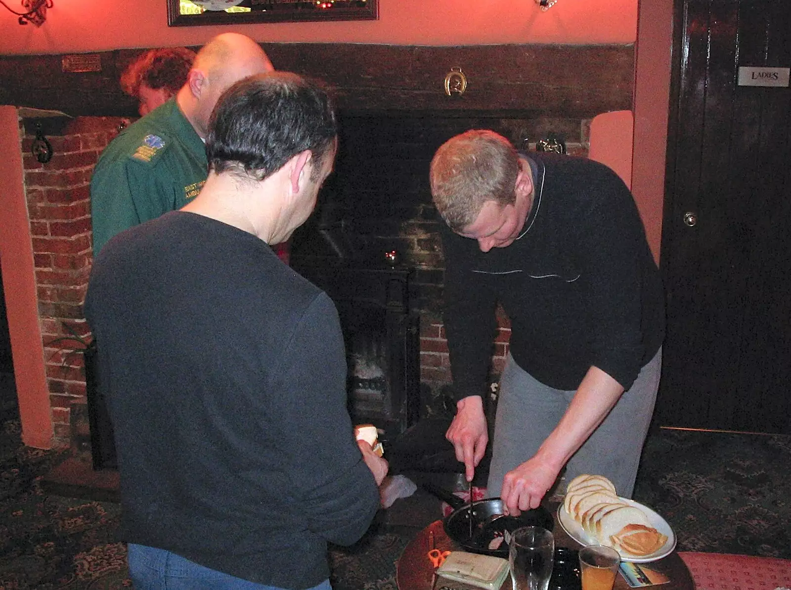 Bill chops sausages up, from Sausages at the Swan Inn, and Revs Gets Decorated, Diss and Brome - 7th January 2005