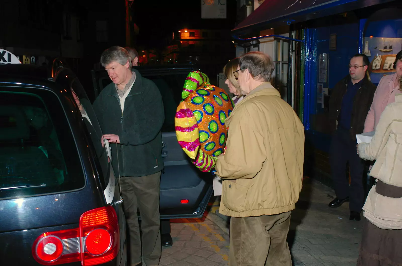 Mike carries his balloon to the taxi, from Mike's 70th Birthday, Christchurch, Dorset - 12th March 2005