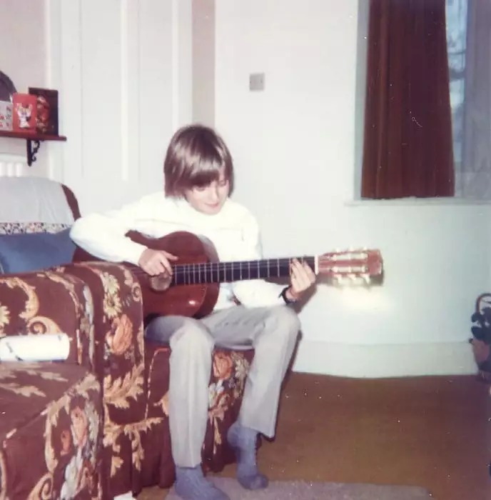 Playing the guitar in the granparent's lounge, from Nosher's Family History - 1980-1985