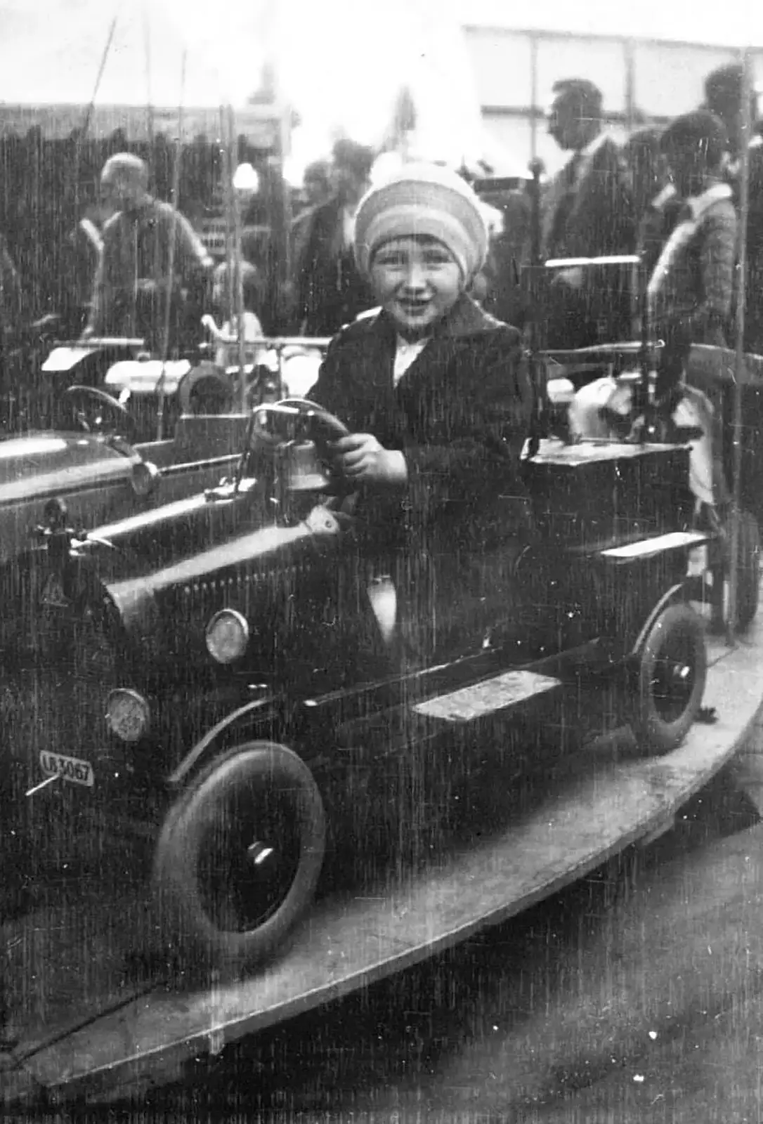 Margaret, aged around 6, on a fairground ride, c. 1930, from Nosher's Family History - 1880-1955