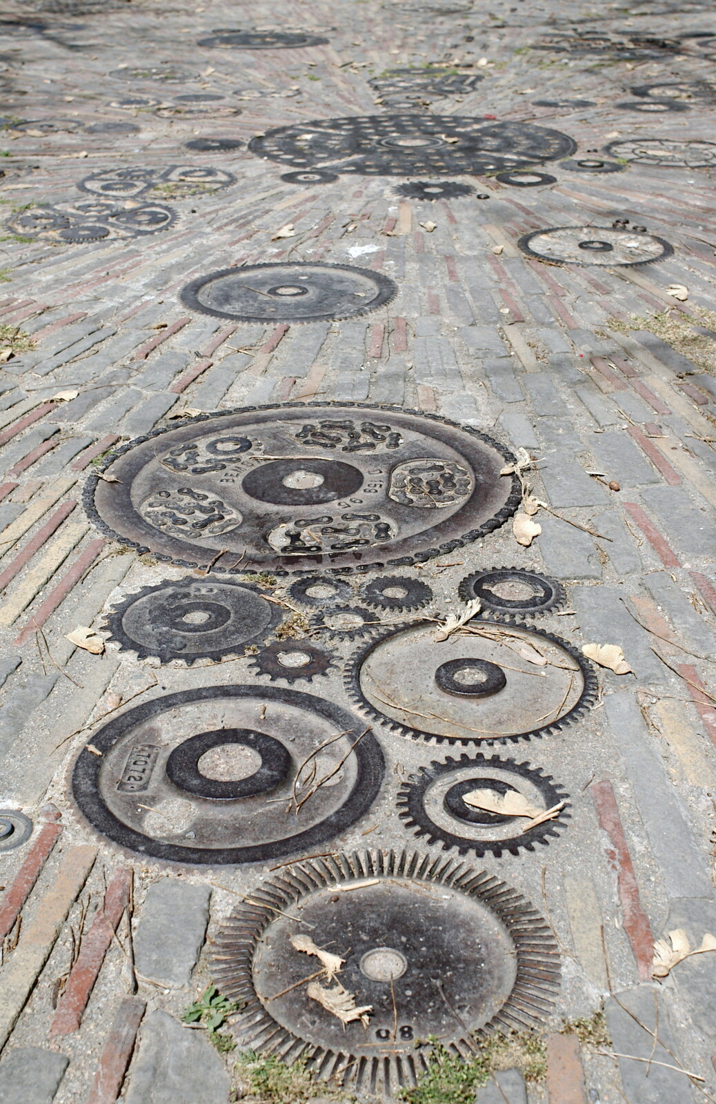 A pavement made up with cogs and gears from Montjuïc and Sant Feliu de Guíxols, Barcelona, Catalunya - 30th April 2005