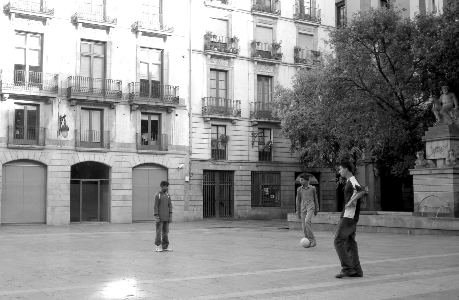 In a quiet side square, some boys play football from Montjuïc and Sant Feliu de Guíxols, Barcelona, Catalunya - 30th April 2005