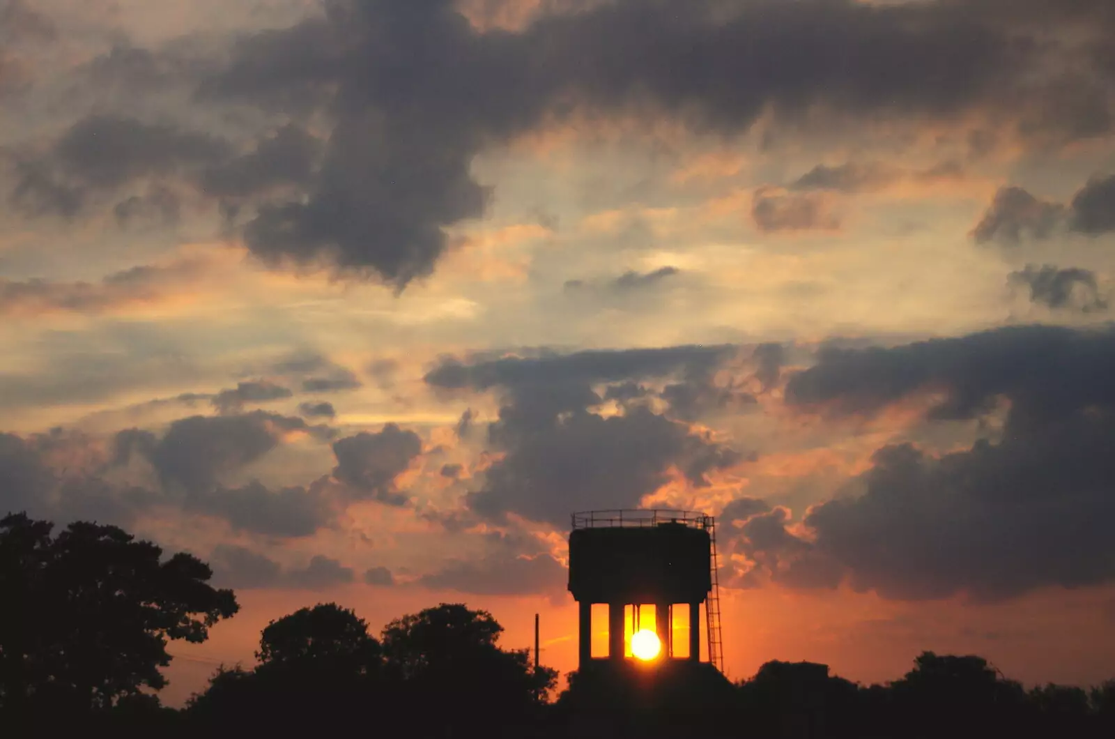 The sun sets through the water tower at Redlingfield, from BSCC Bike Rides and Fun With Diffraction Gratings, Gissing and Diss - 26th May 2005