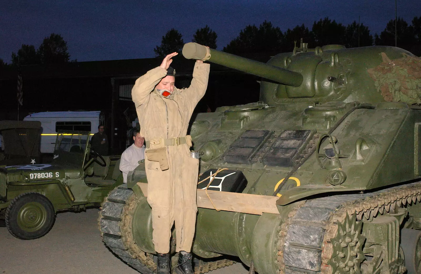 The Sherman driver leaps off the tank, from A 1940s VE Dance At Debach Airfield, Debach, Suffolk - 11th June 2005