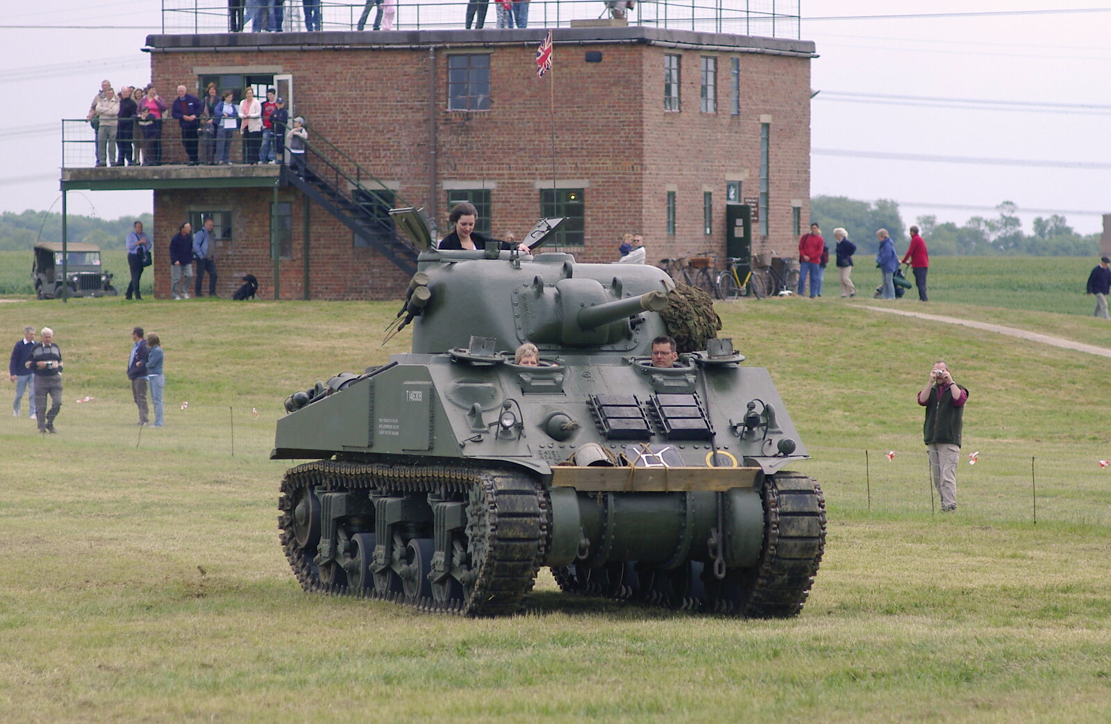 The Sherman tank rumbles past the control tower from An Airfield Open Day, Debach, Suffolk - 12th June 2005