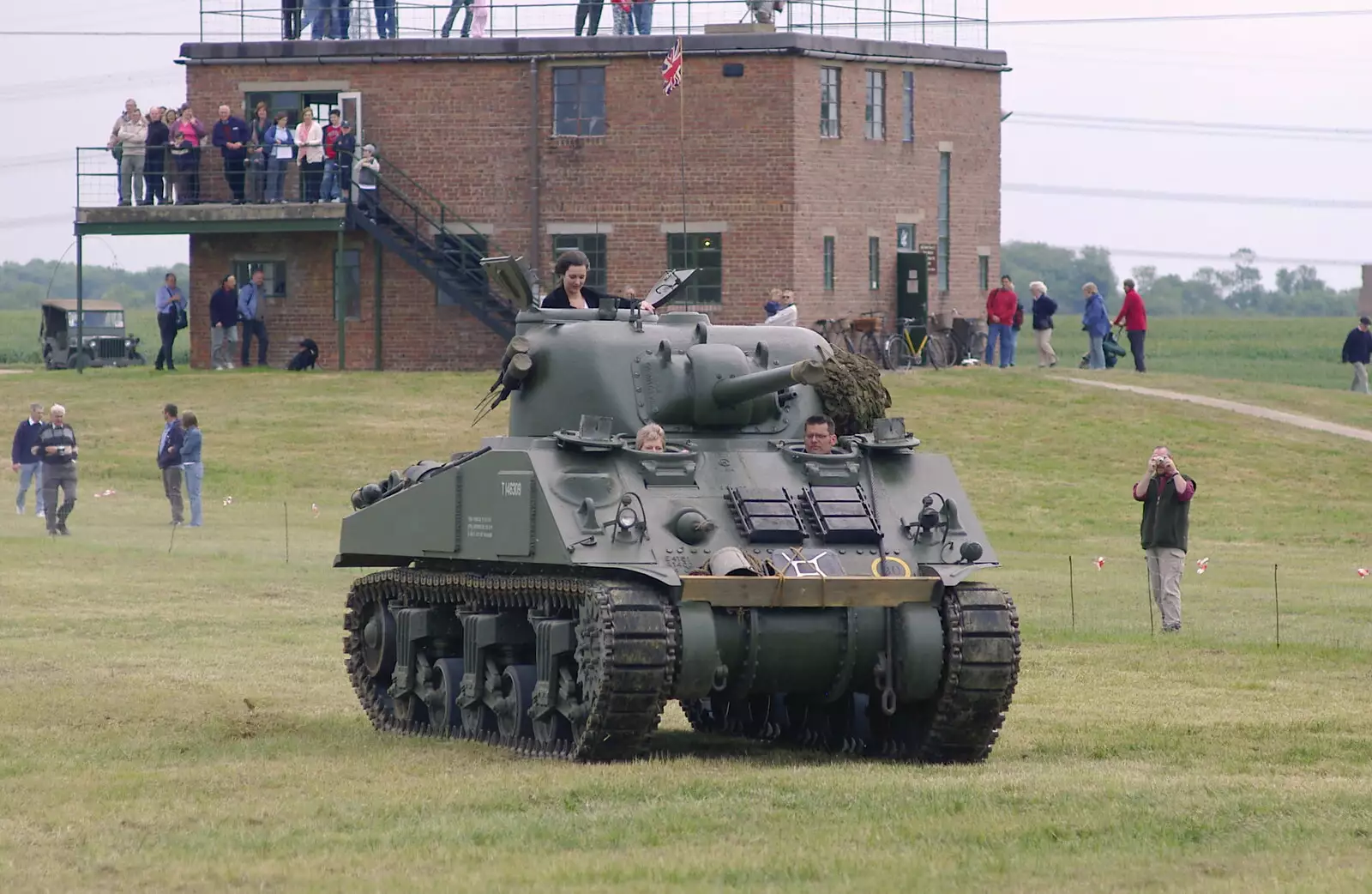 The Sherman tank rumbles past the control tower, from An Airfield Open Day, Debach, Suffolk - 12th June 2005