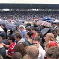 Umbrellas are out as it starts lashing rain, Coldplay Live at Crystal Palace, Diss Publishing and Molluscs, Diss and London - 28th June 2005
