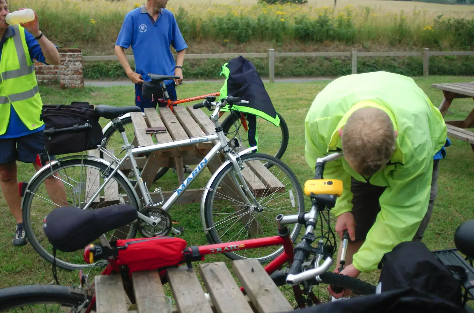 Bill does some tyre pumping, from The BSCC Charity Bike Ride, Walberswick, Suffolk - 9th July 2005