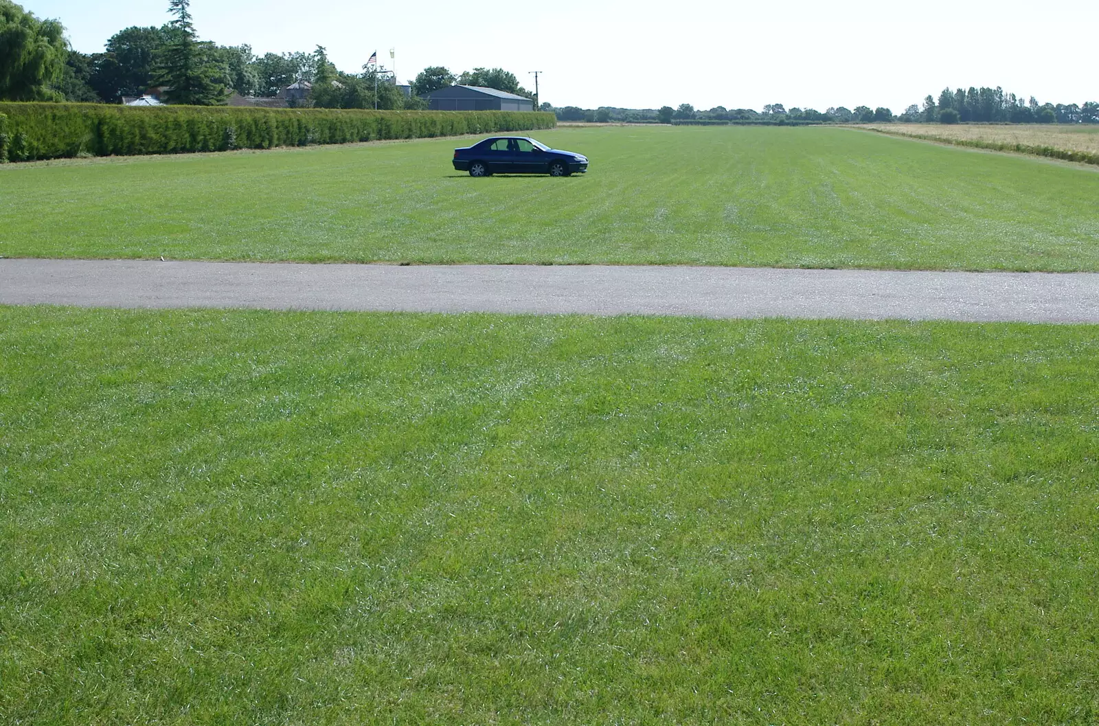 An inconsiderate car, right on the runway, from A Day With Janie the P-51D Mustang, Hardwick Airfield, Norfolk - 17th July 2005