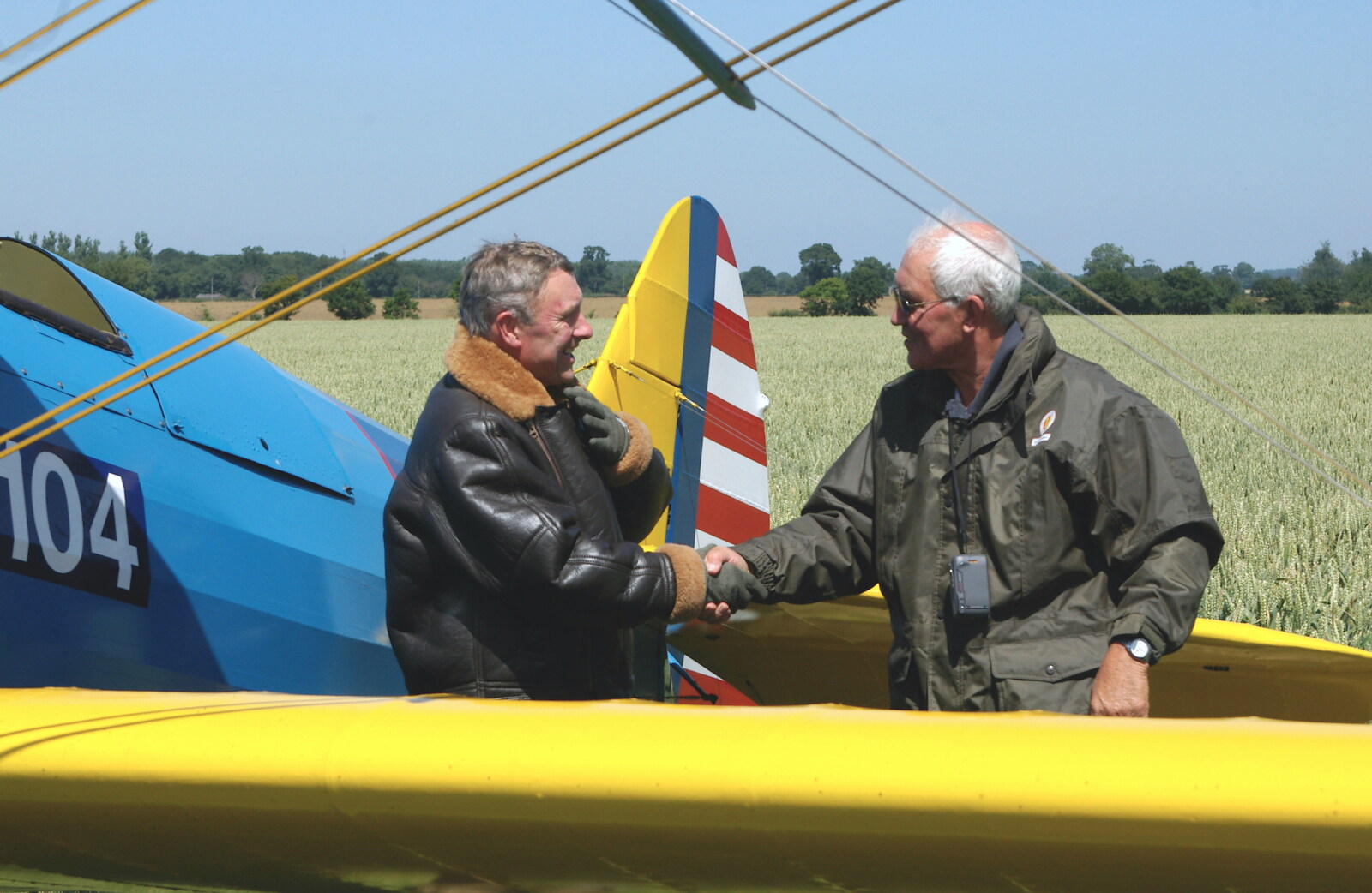 The Stearman pilot gets a handshake from A Day With Janie the P-51D Mustang, Hardwick Airfield, Norfolk - 17th July 2005