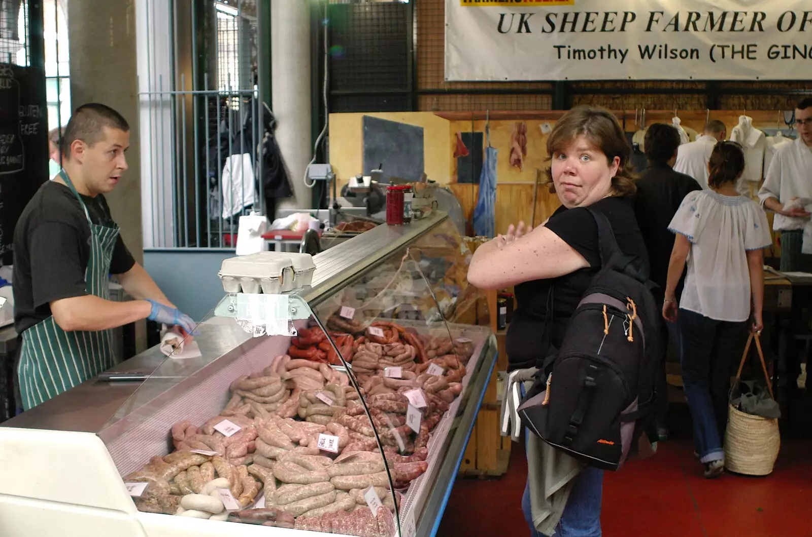 Sis gets some sausages, from Borough Market and North Clapham Tapas, London - 23rd July 2005