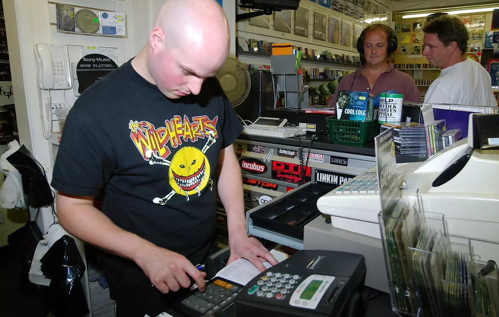 Mark on the till, from Richard Panton's Van and Alex Hill at Revolution Records, Diss and Cambridge - 29th July 2005