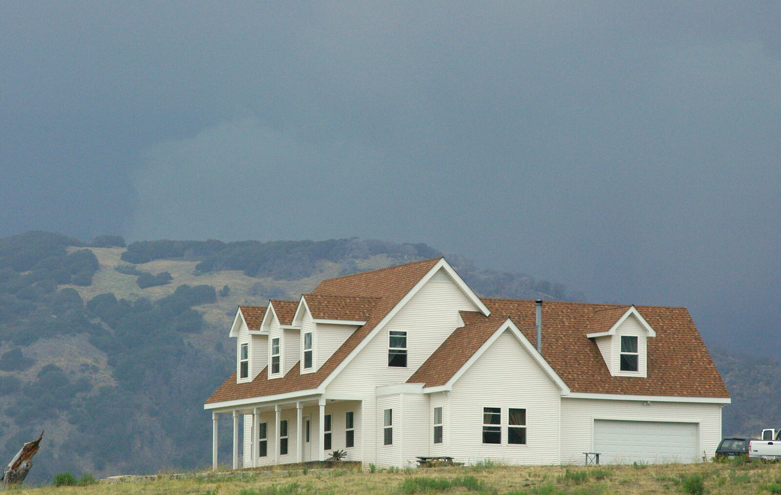 Dark skies amass behind a house on a hill from Route 78: A Drive Around the San Diego Mountains, California, US - 9th August 2005