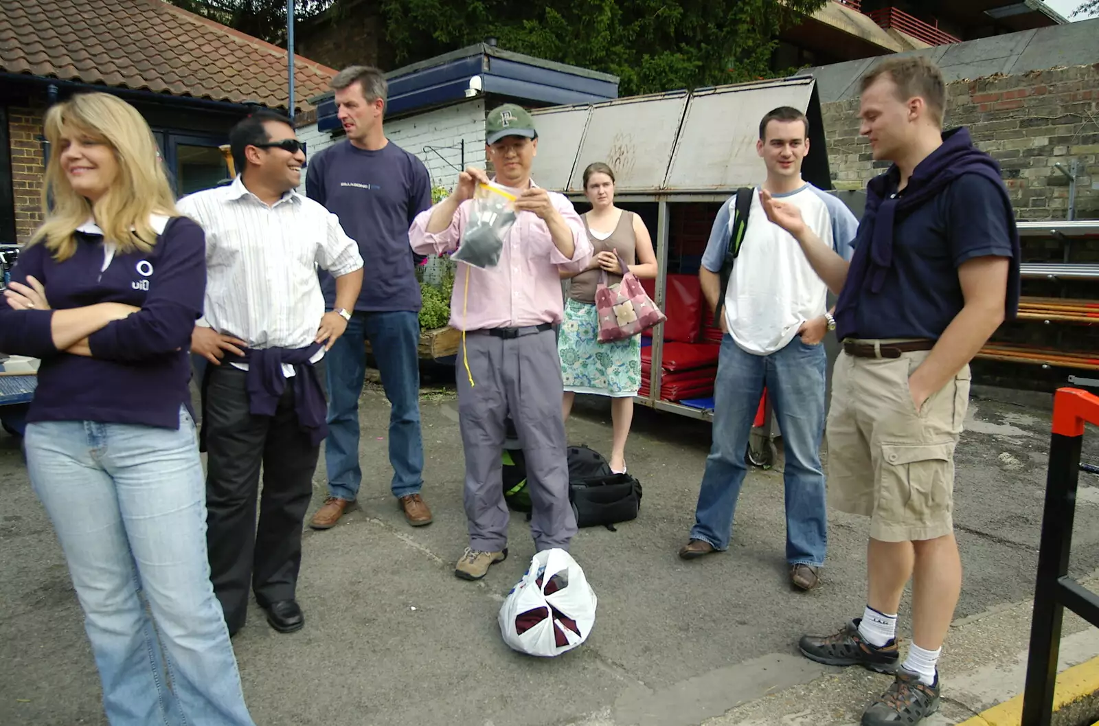 James seals his wallet away in a waterproof pouch, from Qualcomm goes Punting on the Cam, Grantchester Meadows, Cambridge - 18th August 2005