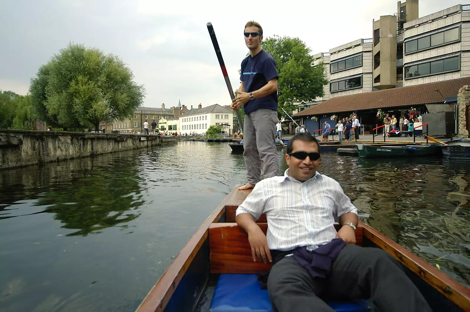 Anwar kicks back as Ben does the work, from Qualcomm goes Punting on the Cam, Grantchester Meadows, Cambridge - 18th August 2005