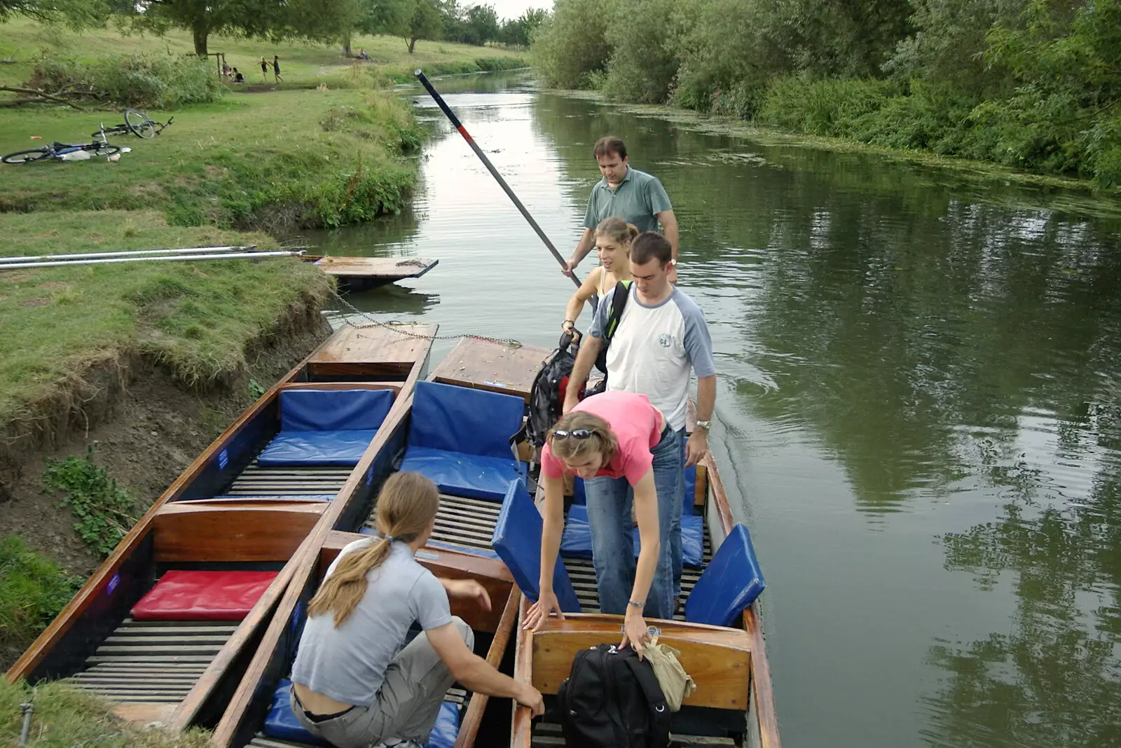 Liviu's punts arrives and moors up, from Qualcomm goes Punting on the Cam, Grantchester Meadows, Cambridge - 18th August 2005