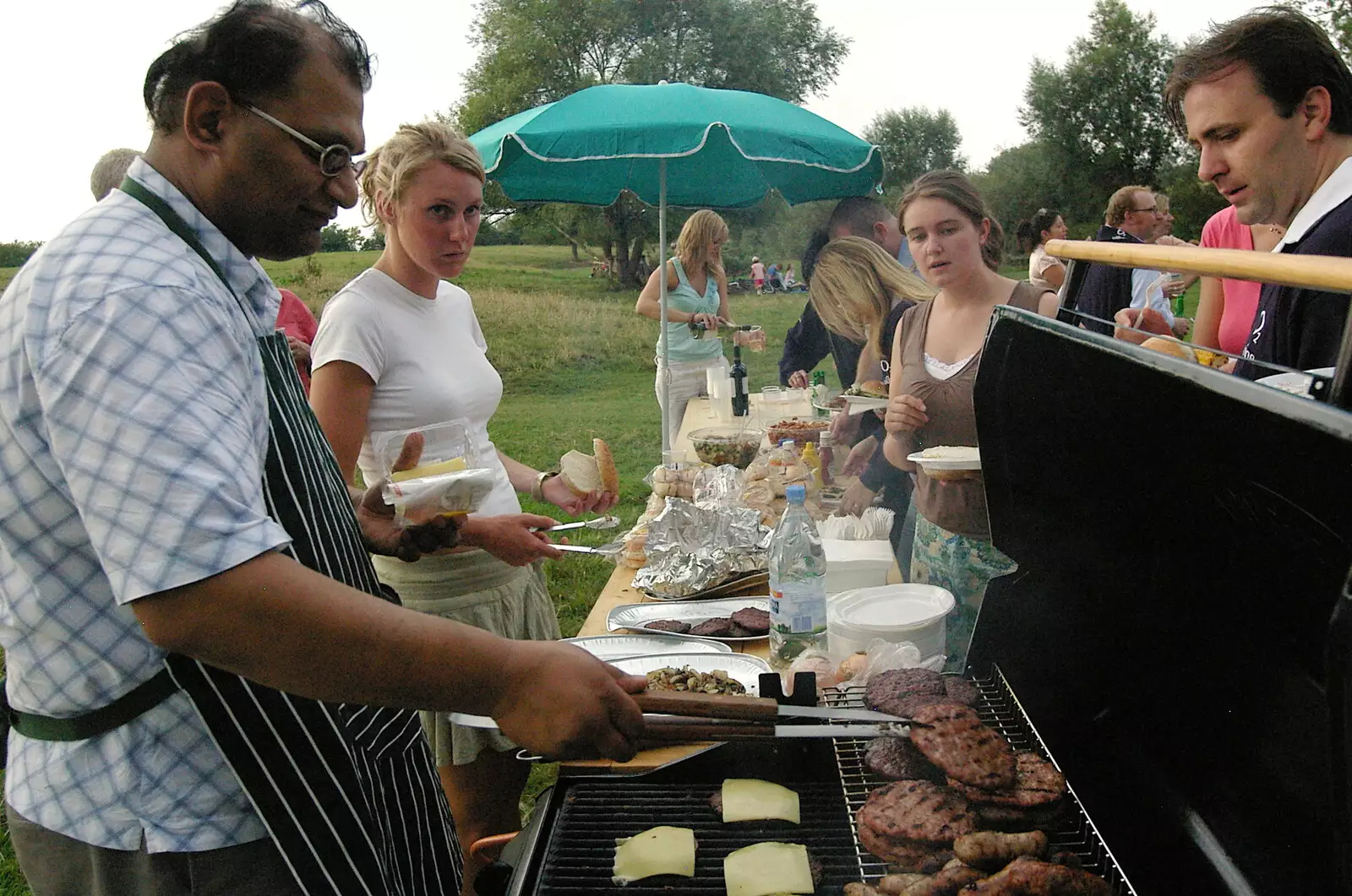 Isobel scopes out the burgers, from Qualcomm goes Punting on the Cam, Grantchester Meadows, Cambridge - 18th August 2005