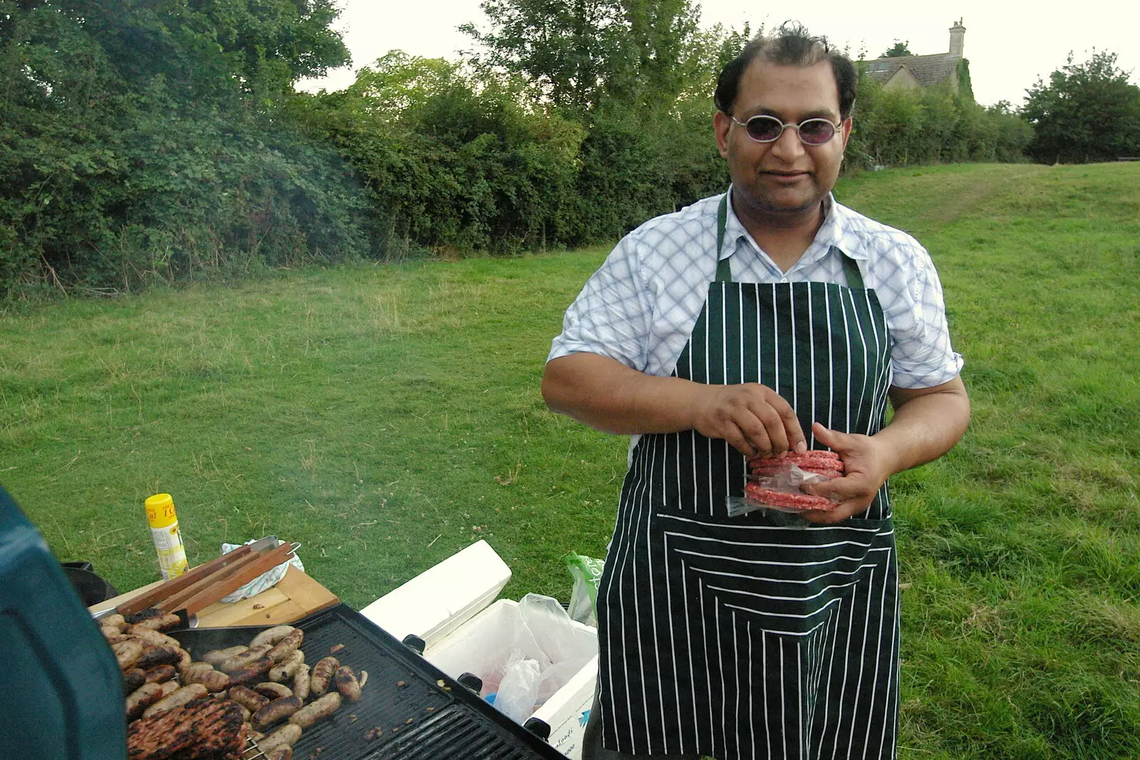 Bill with a bunch of burgers ready to barbeque, from Qualcomm goes Punting on the Cam, Grantchester Meadows, Cambridge - 18th August 2005