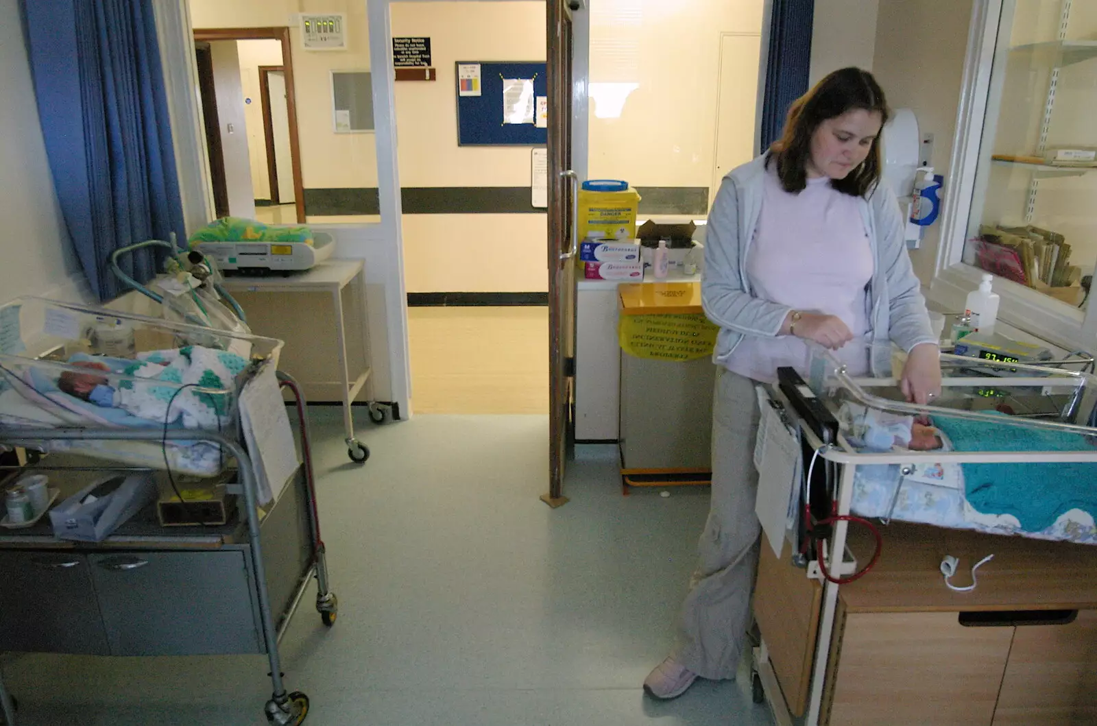 Claire looks at Matthew, from Life on the Neonatal Ward, Dairy Farm and Thrandeston Chapel, Suffolk - 26th August 2005