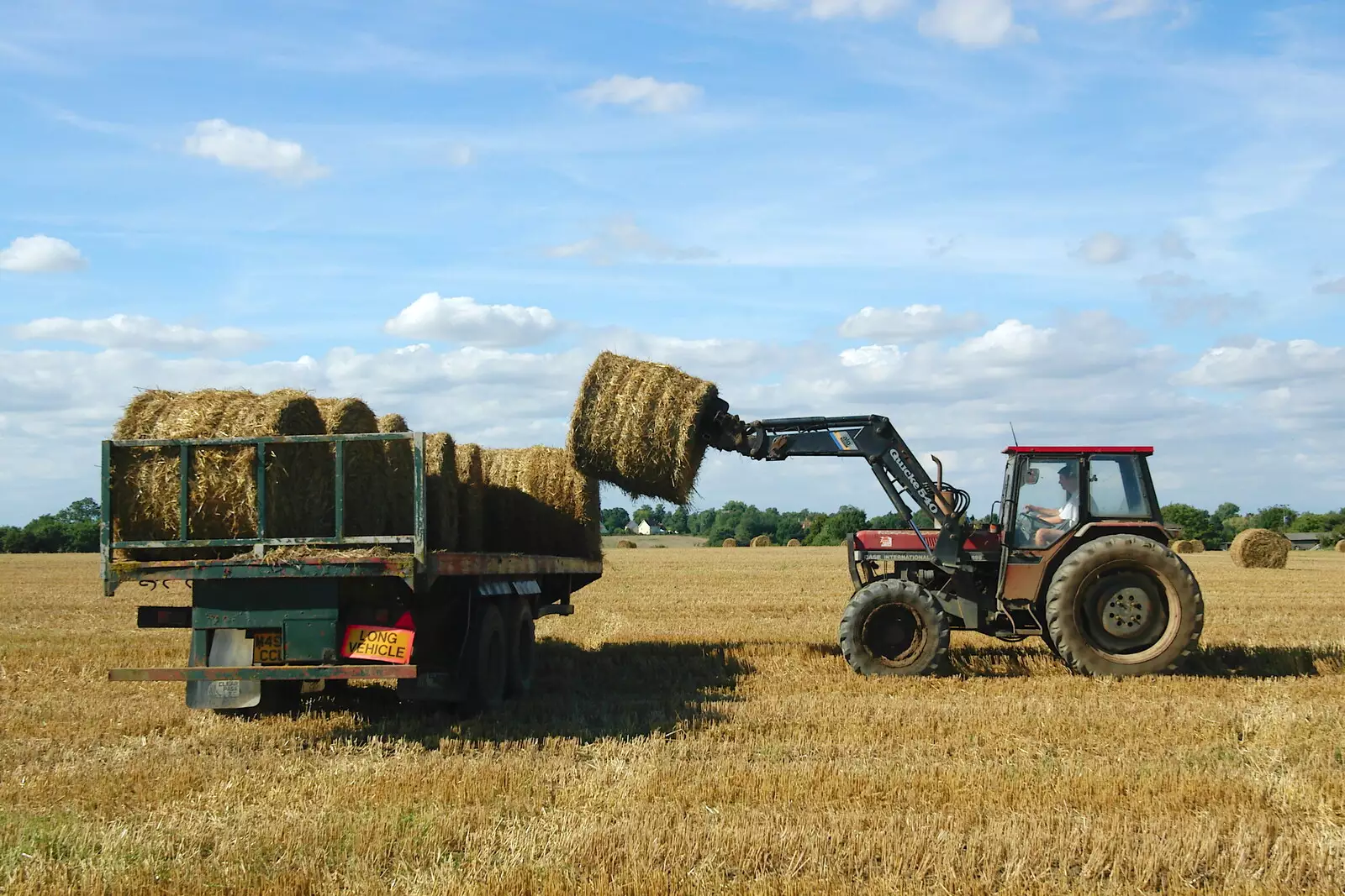 A bale is loaded onto a trailer, from Life on the Neonatal Ward, Dairy Farm and Thrandeston Chapel, Suffolk - 26th August 2005