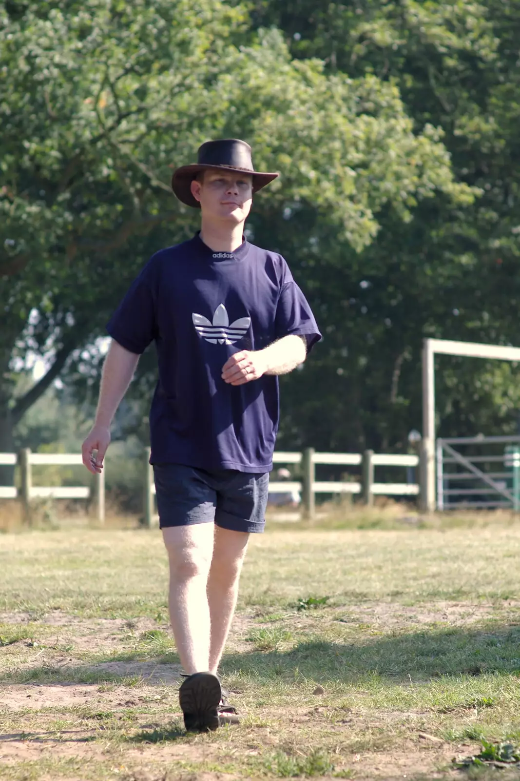 Mikey P strolls back with his Aussie hat on, from Picnic at the Heath, Knettishall, Norfolk - 4th September 2005