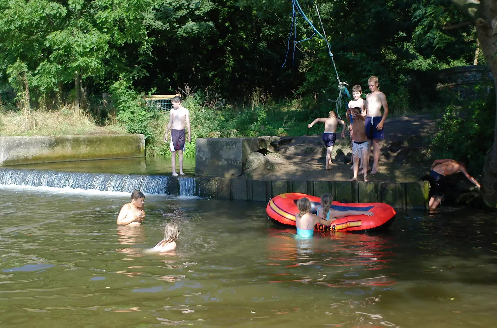 Kids swing off a rope and jump into the river, from Picnic at the Heath, Knettishall, Norfolk - 4th September 2005