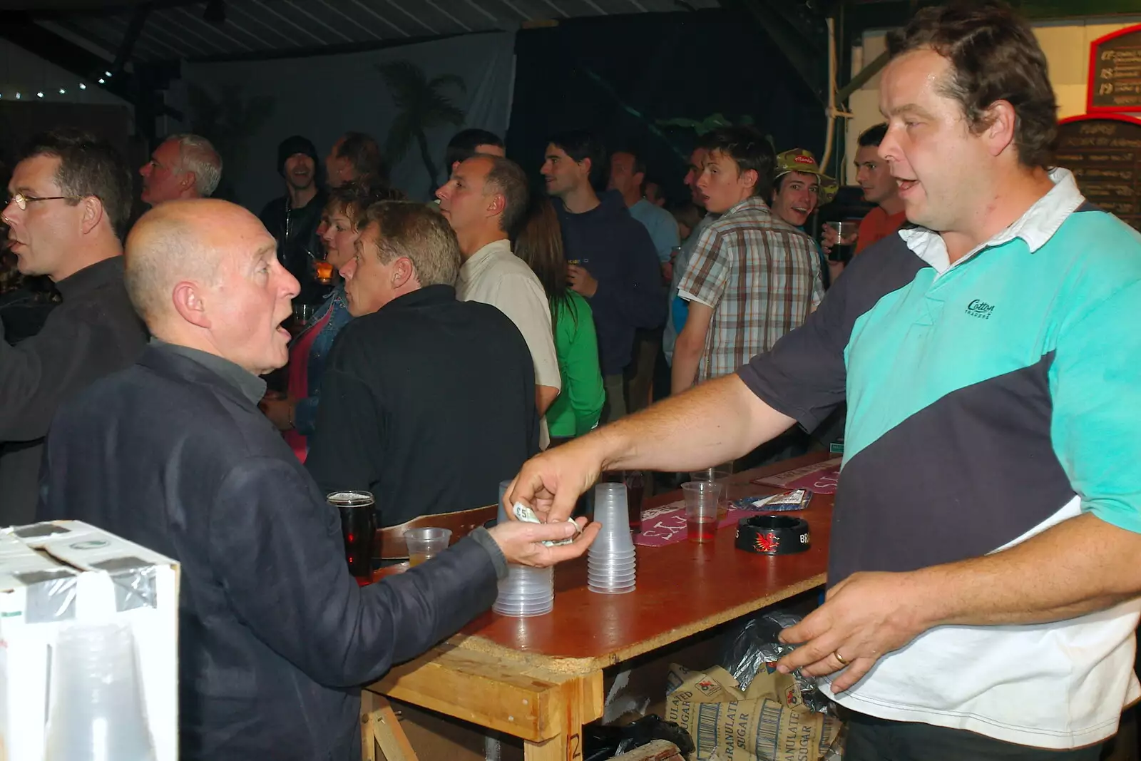 A transaction is completed, from The Banham Barrel Beer Bash, Banham, Norfolk - 17th September 2005