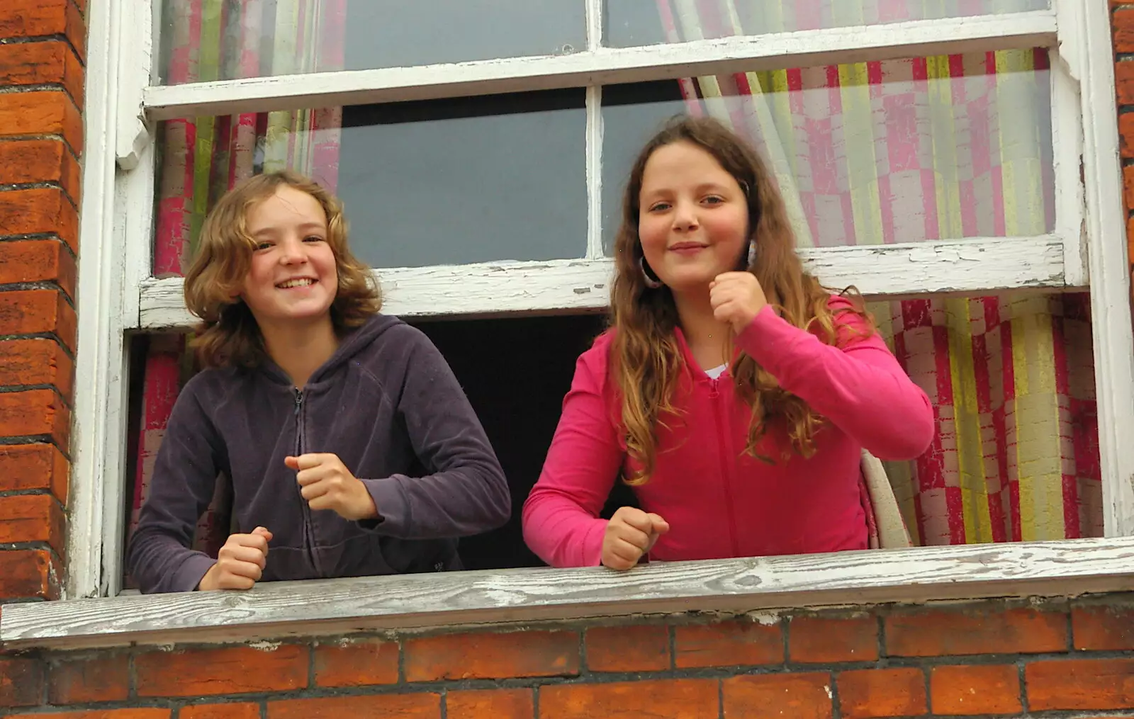 A couple of girls dance along from their window, from Save Hartismere: a Hospital Closure Protest, Eye, Suffolk - 17th September 2005