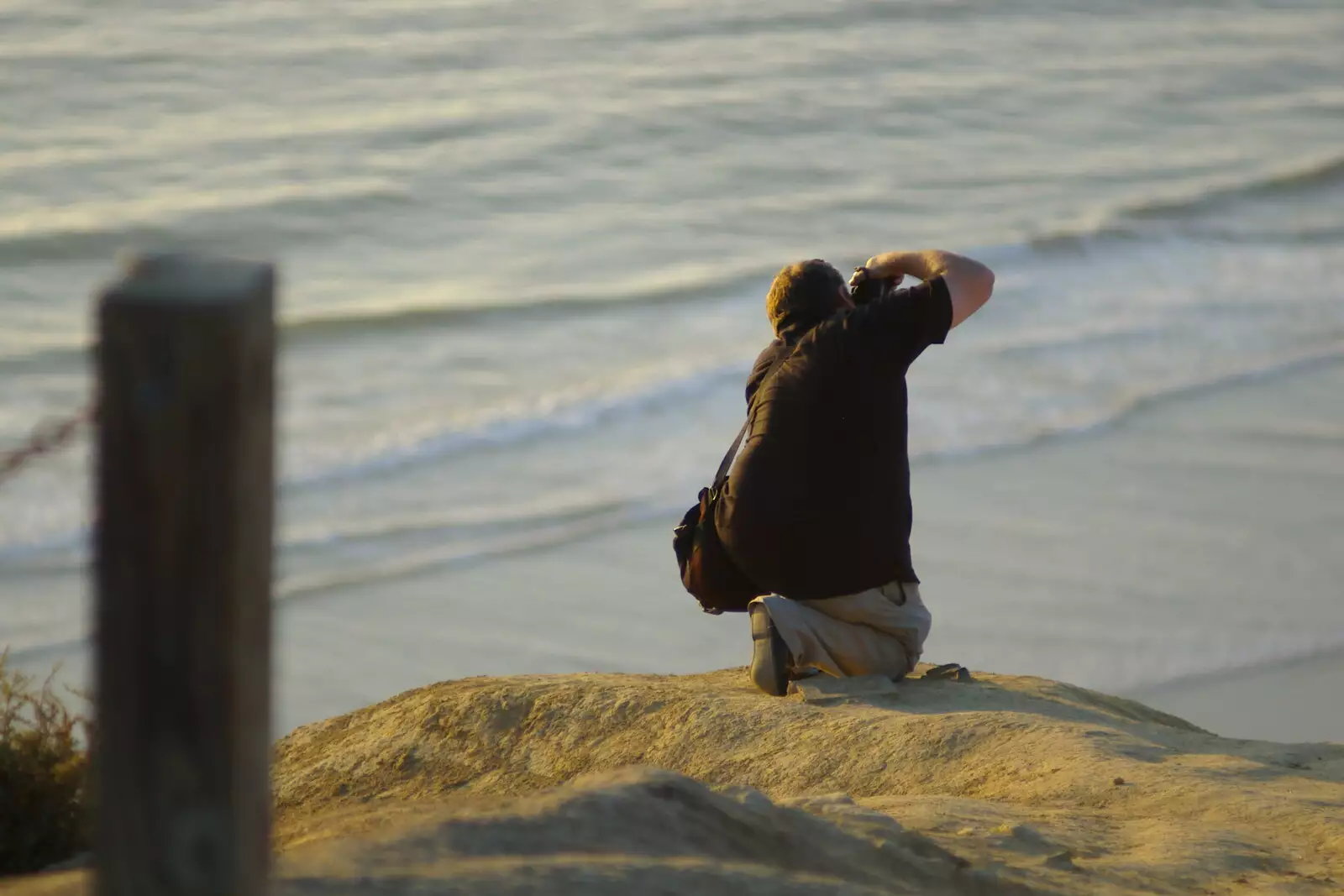 Ken kneels down to take a shot along the beach, from San Diego Four, California, US - 22nd September 2005