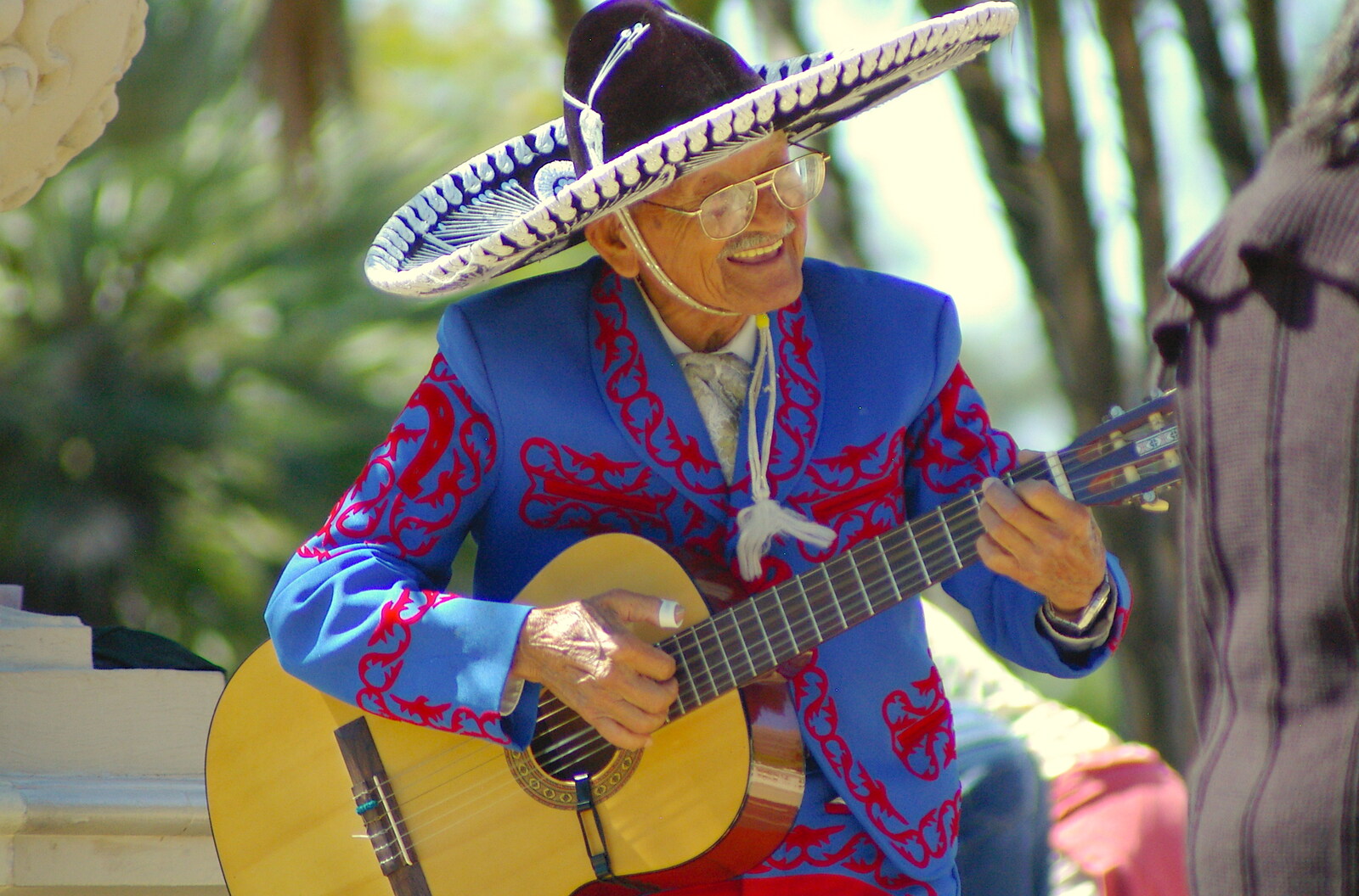 Scenes and People of Balboa Park, San Diego, California - 25th September 2005: An old Mexican guy sings version of 'Guantanamera'