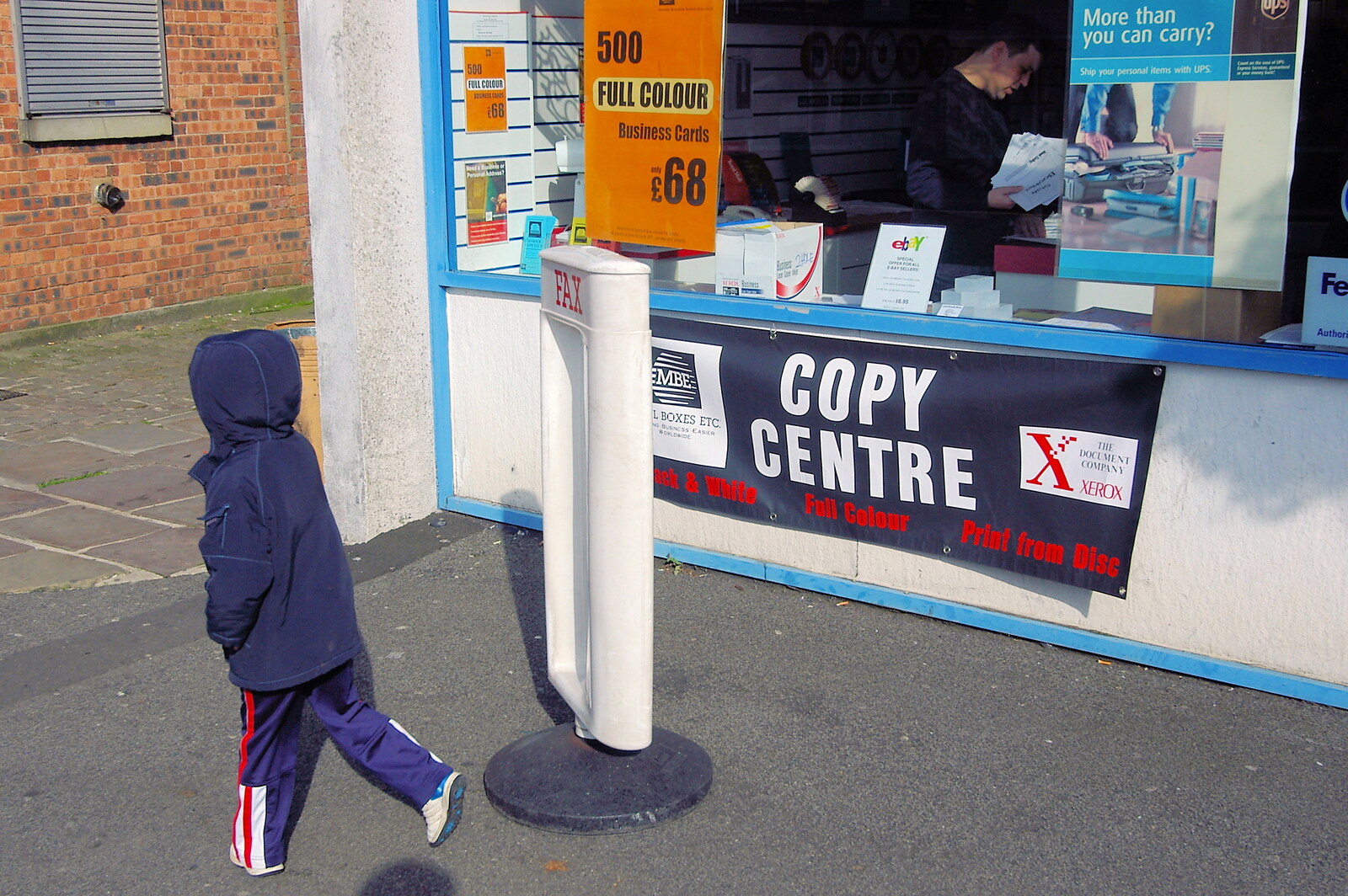A Trip Around Macclesfield and Sandbach, Cheshire - 10th September 2005: A kid spins a sign around